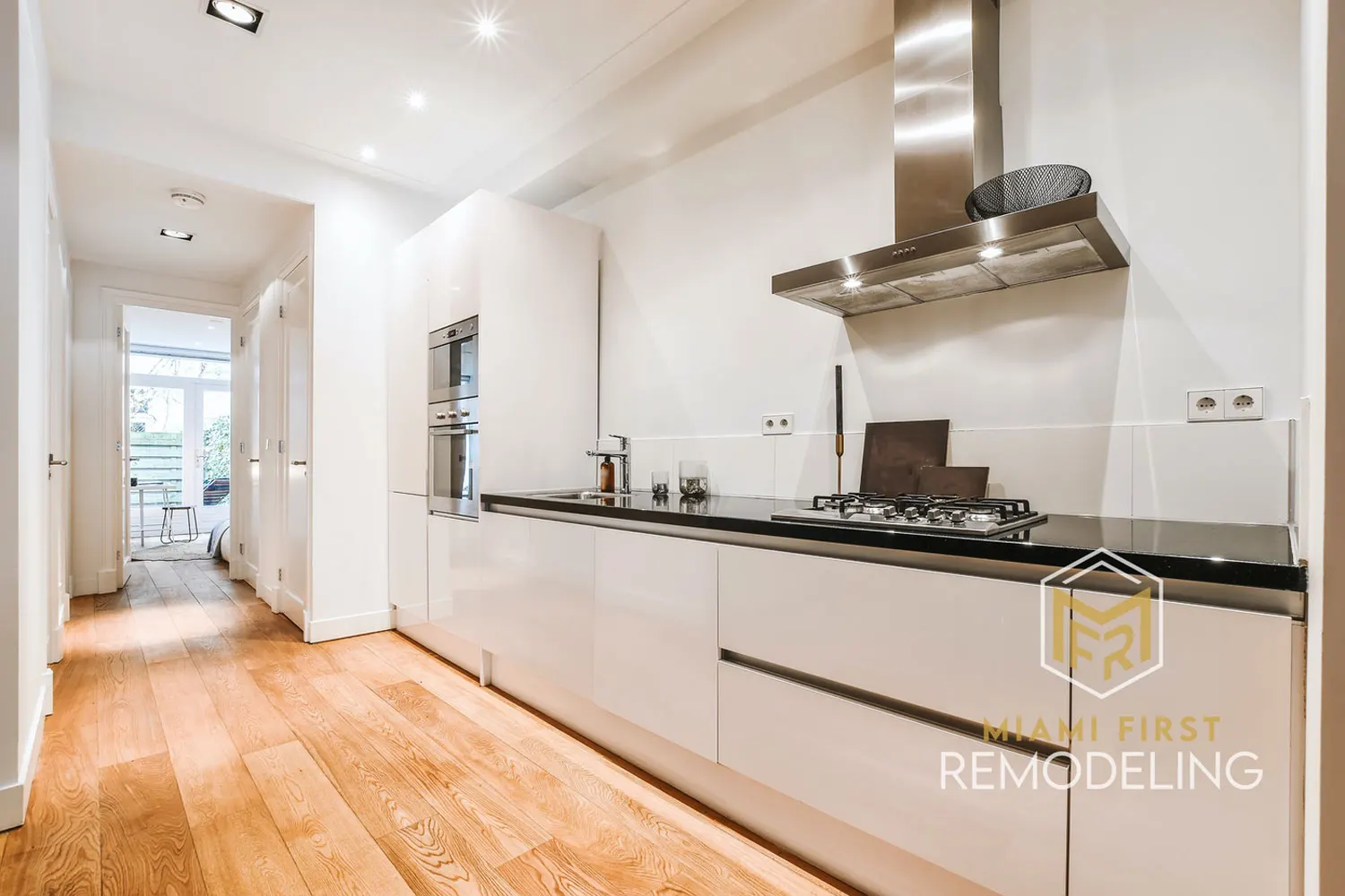 Two-tone Miami kitchen with white shaker perimeter and contrasting island — Miami First Remodeling
