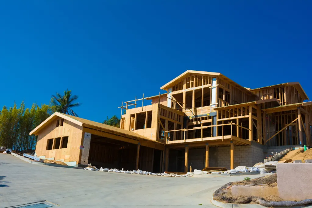 Timber framing of a two-storey home going up over a block base