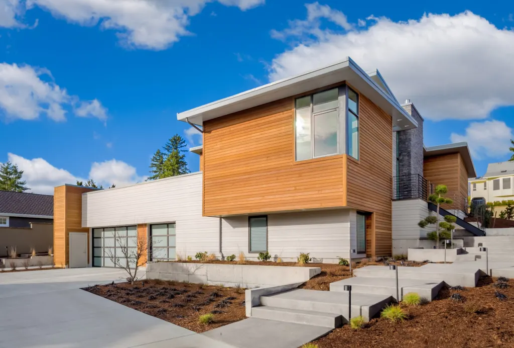 Modern home with a white rendered facade and timber cladding