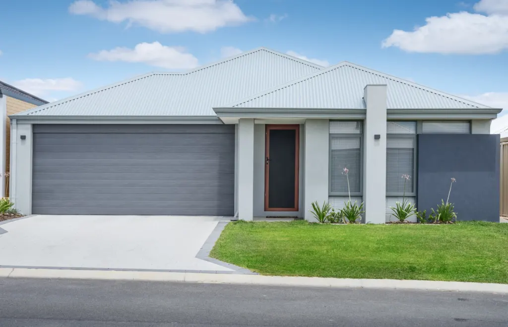 Single-story home with a soft grey exterior and white trim