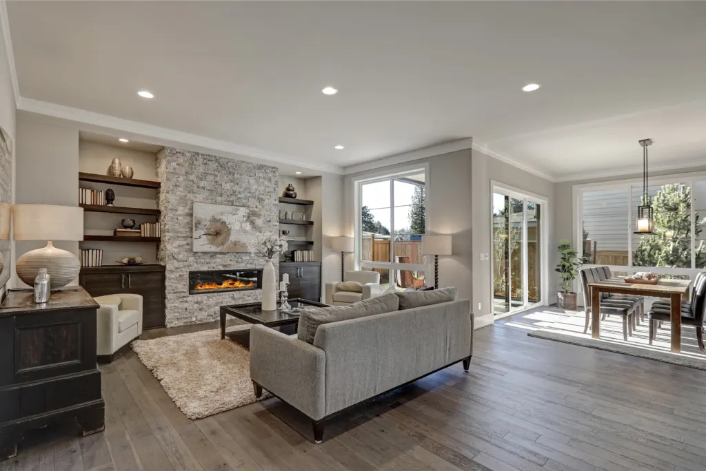 Living room in soft greys with a stone fireplace surround