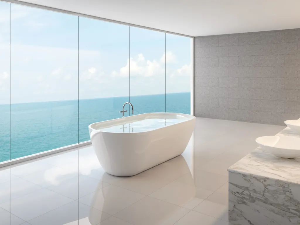 Marble-tiled bathroom with a freestanding tub and ocean view