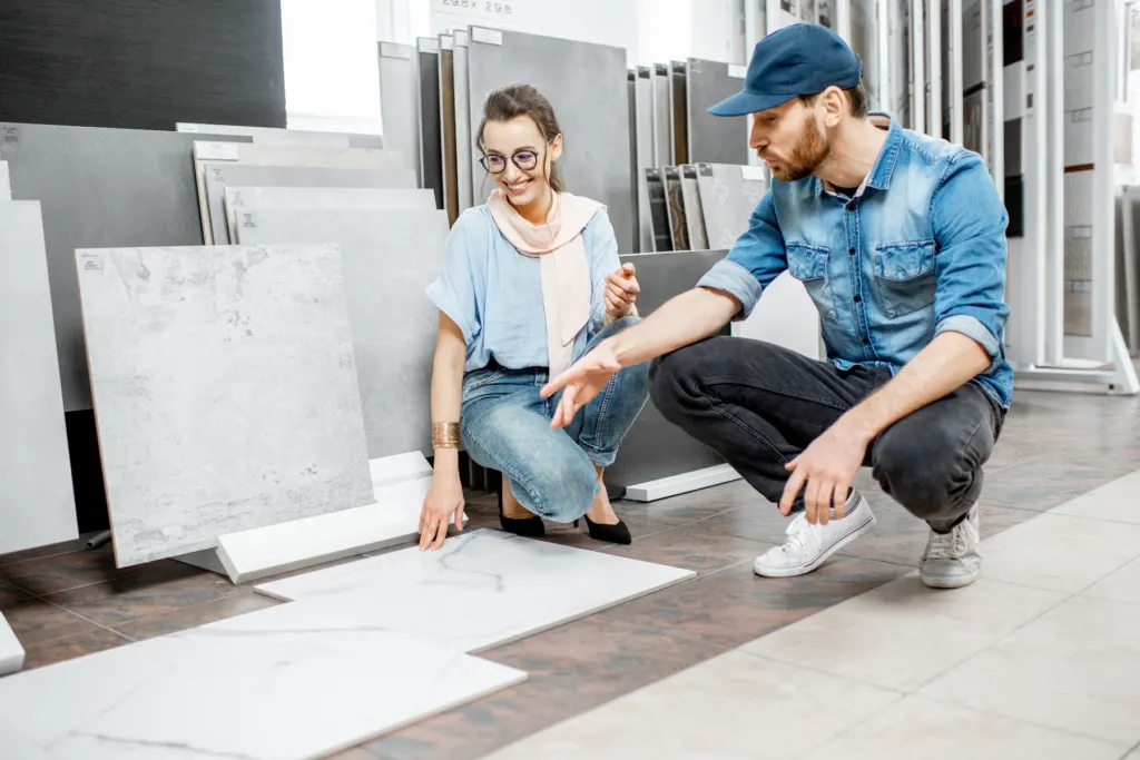 Customers choosing tile with a specialist in a showroom